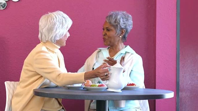 两名多种族的高级妇女在咖啡店里交谈