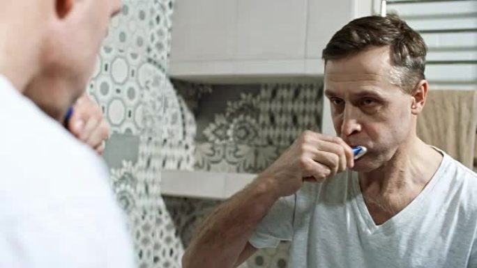 男人刷牙时照镜子