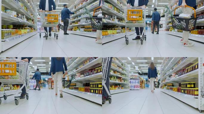 超市的低角度镜头: 罐头食品区，顾客浏览货架和购买产品。