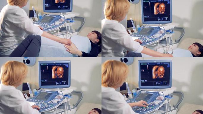 借助特殊设备对孕妇进行超声波检查