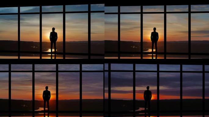 男性站在日落背景上的全景窗户附近。时间流逝