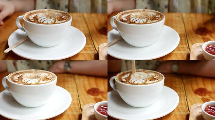 一个女人在咖啡杯中倒糖的特写镜头