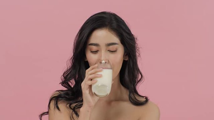 喝牛奶的迷人亚洲女人。