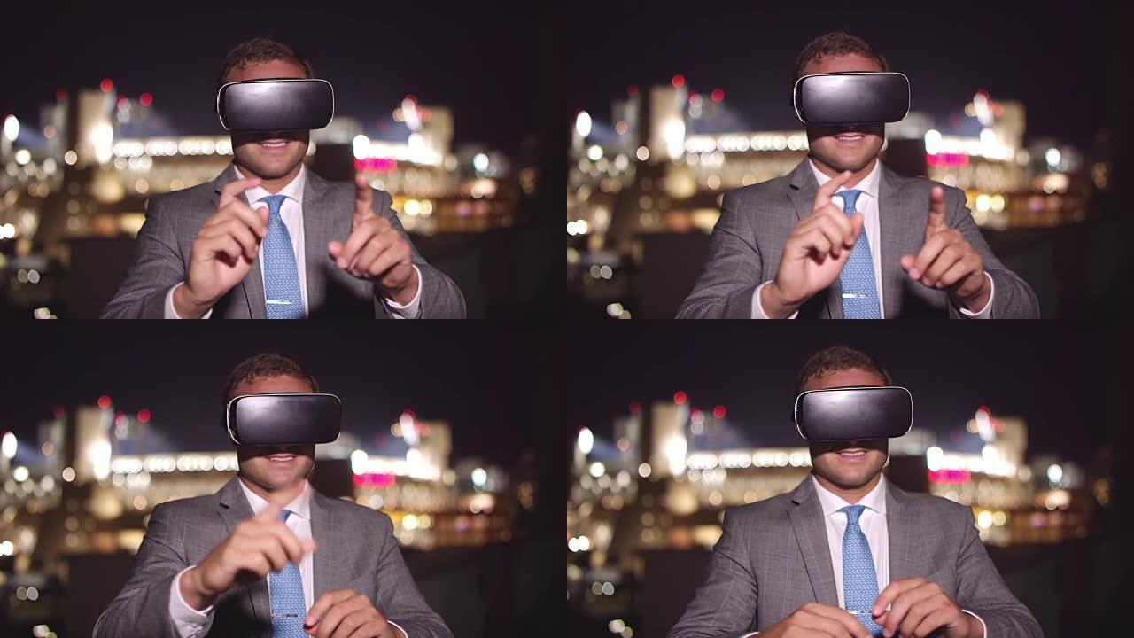 年轻的商人晚上戴着虚拟现实耳机在虚拟屏幕上打字，背景是城市市中心的灯光