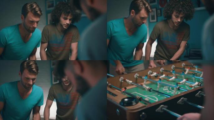 男人们在公寓里踢桌面足球