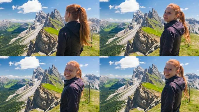 年轻女子徒步旅行者从塞塞达山顶欣赏壮丽的景色，对着镜头微笑
