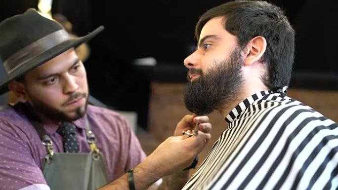 理发师用剪刀修饰男人的胡须