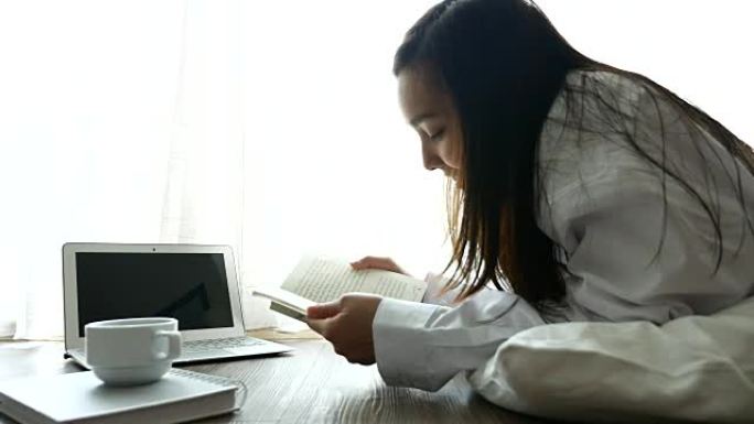 在舒适的日子里躺在家里看书，生活方式的概念