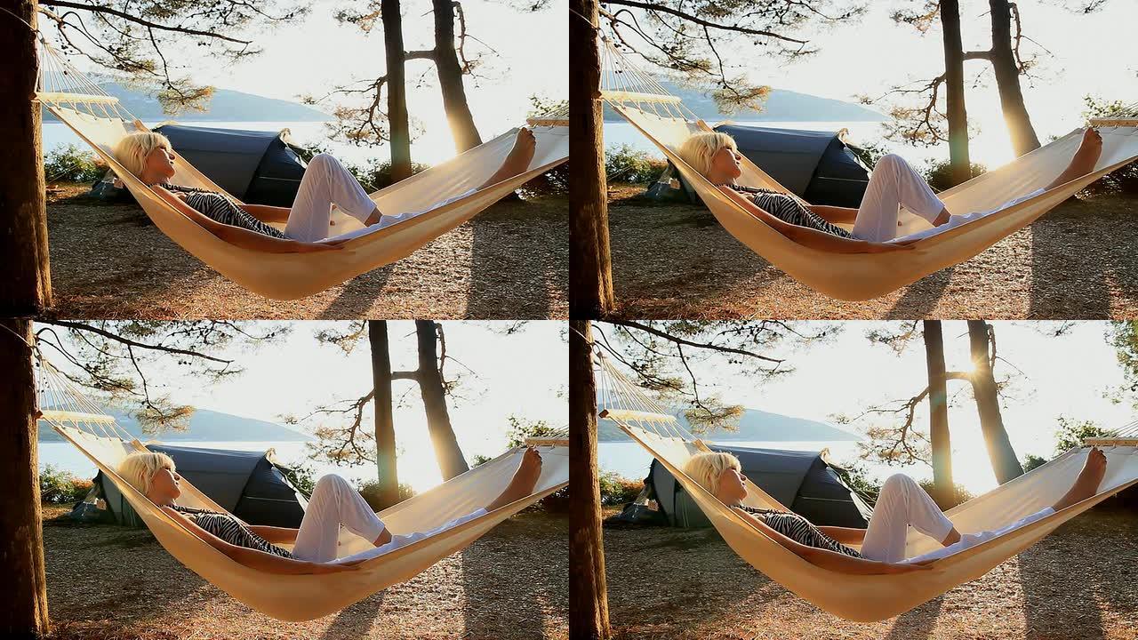 HD DOLLY：在海滩上的吊床上放松的女人