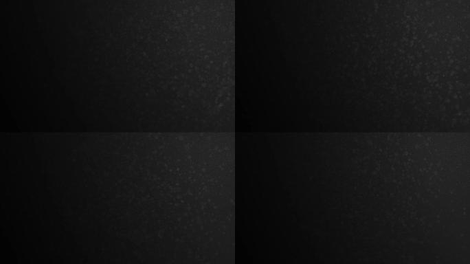 黑色背景上的dop模糊在空气中流动的有机粉尘。浮点粒子与散景的3d动画。