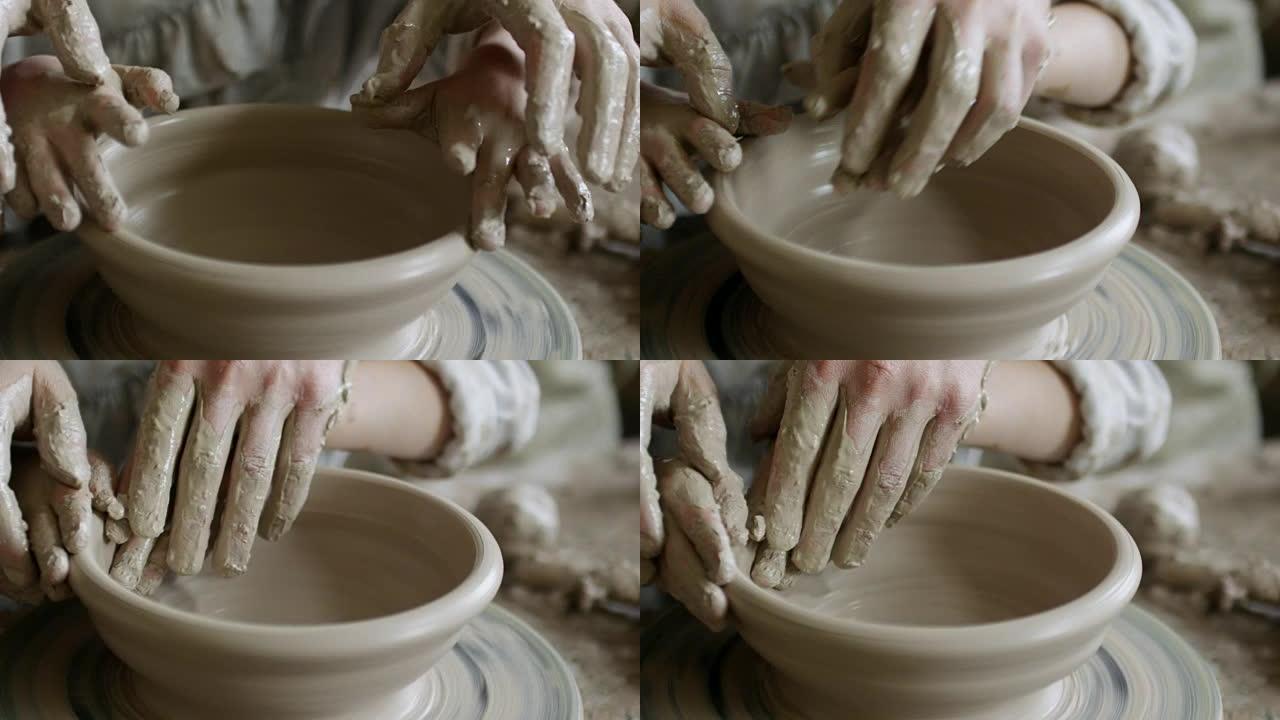 人类和儿童的手制作陶器