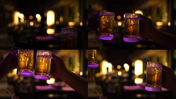 慢动作FHD镜头特写烤酒和碰杯啤酒，在酒吧和餐厅一起欢呼，放松和喝酒的概念