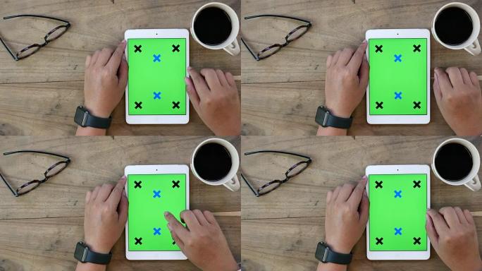 使用绿色屏幕的数字平板电脑的上图，垂直