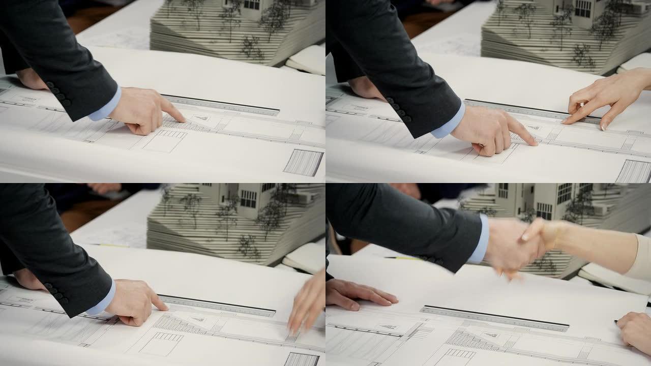 建筑师握手看图纸合作愉快达成共识