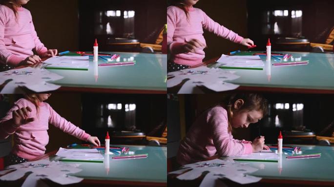 相机在带文具的桌子上用铅笔在粉红色毛衣绘画的小可爱高加索女孩儿童上向左滑动