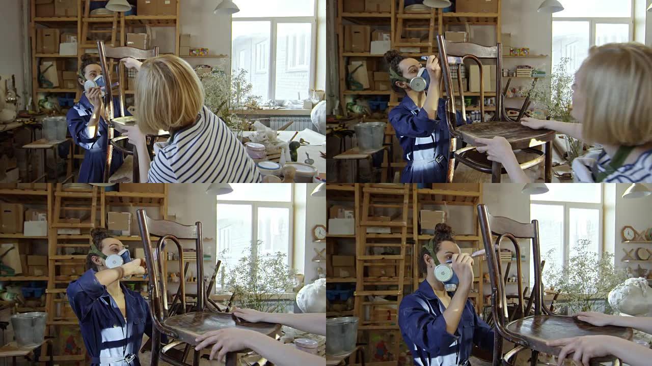 妇女在木制家具上涂清漆