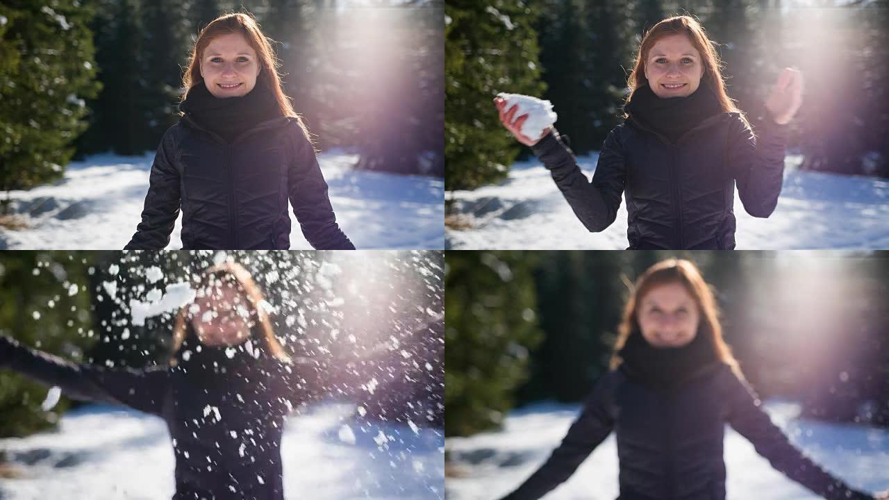 女人向空中扔雪雪花飞溅面对镜头女子冬季