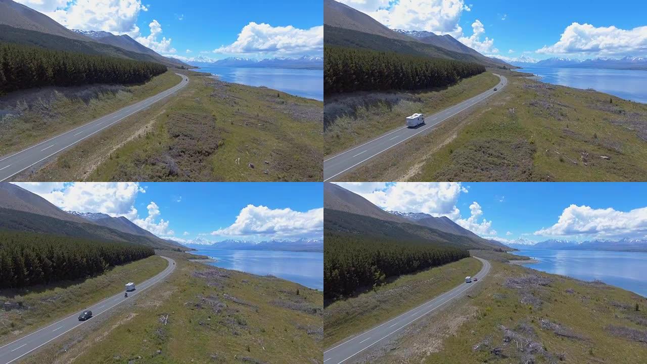 空中拍摄湖泊和道路上的山脉