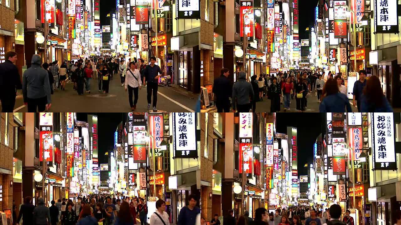 在日本东京，晚上在歌舞伎町上散步的人群