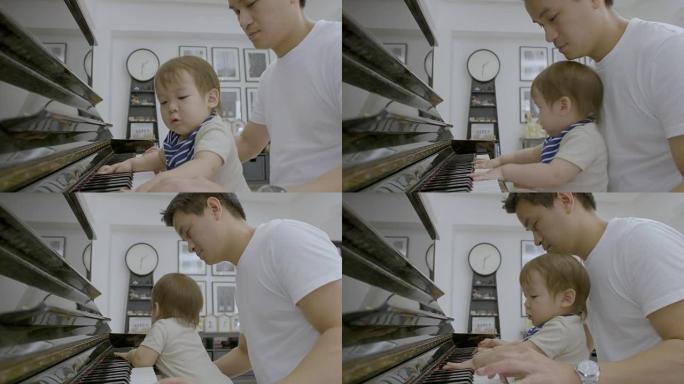 爸爸和他的小儿子一起玩，教弹钢琴