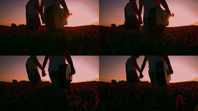 日落时分，SLO MO浪漫情侣在田野里散步