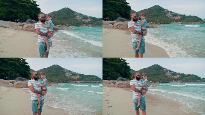 带着女儿的父亲喜欢在沙滩上散步