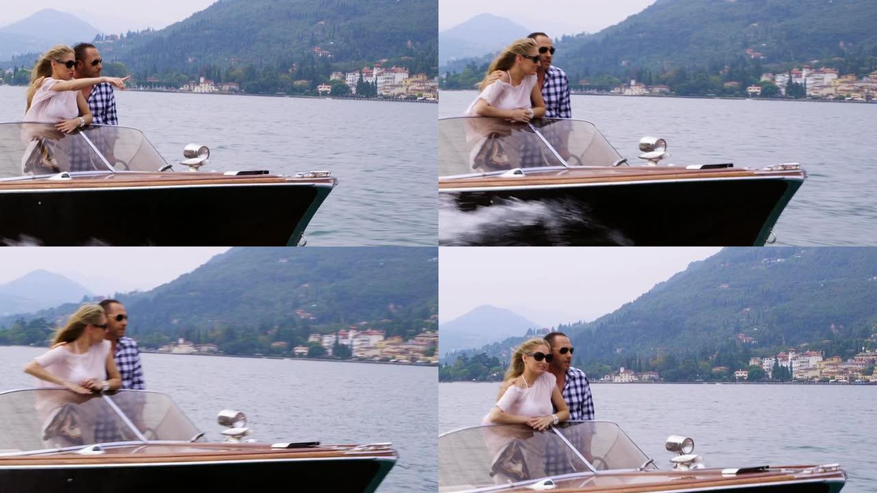 情侣在游艇上开车汽艇拥抱