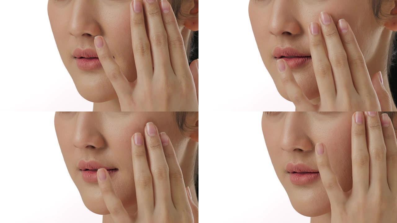 近距离肖像美丽的年轻亚洲女人触摸脸和健康的皮肤在慢动作护肤概念