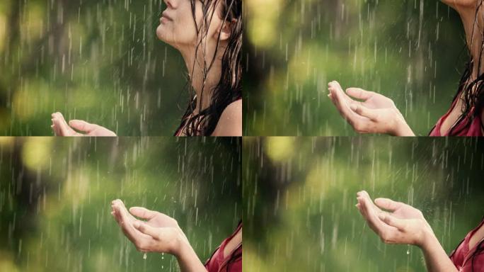 女人在夏雨中享受并握住她的手