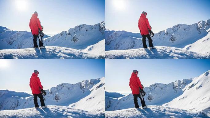 白雪皑皑的山顶上的滑雪者准备撞上山坡