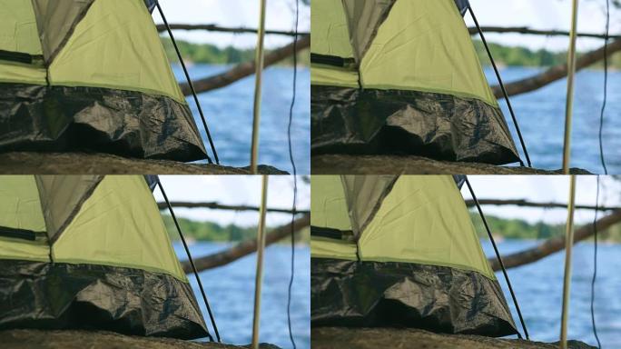 在瑞典湖边的帐篷里露营