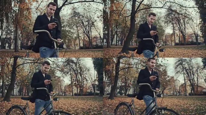 男子在推自行车时打字短信