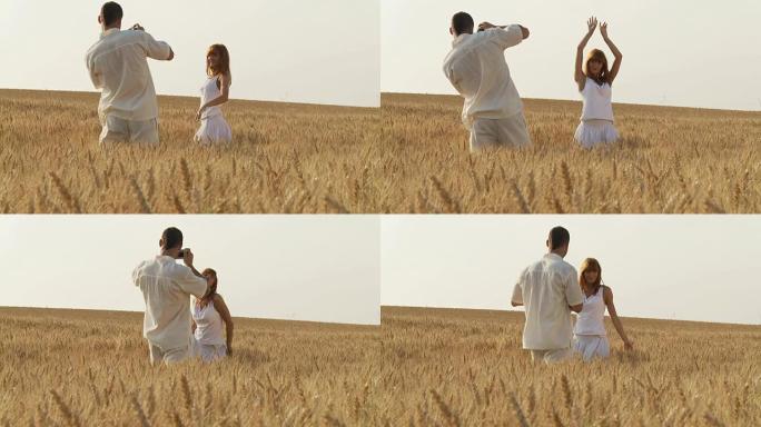 高清：一名年轻男子在拍摄一名身穿小麦的女子的照片