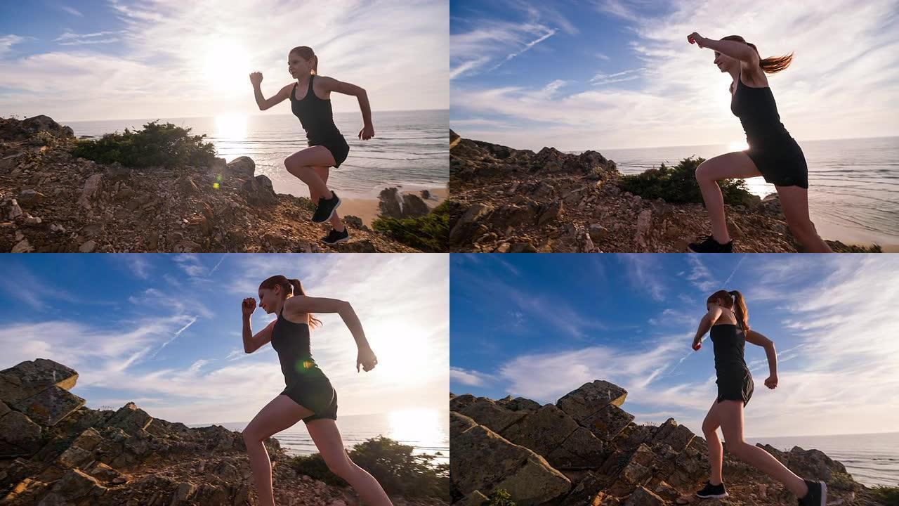 年轻的女运动员在海边的岩石地形上奔跑