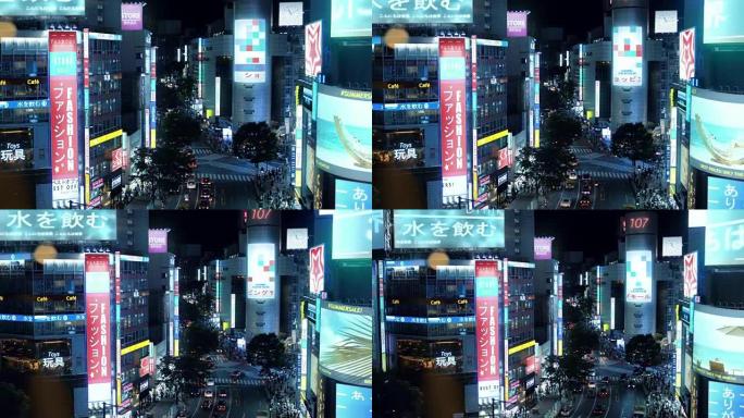 大角度拍摄东京，大城市中心有摩天大楼，发光的广告广告牌，繁忙的交通和夜间人群。