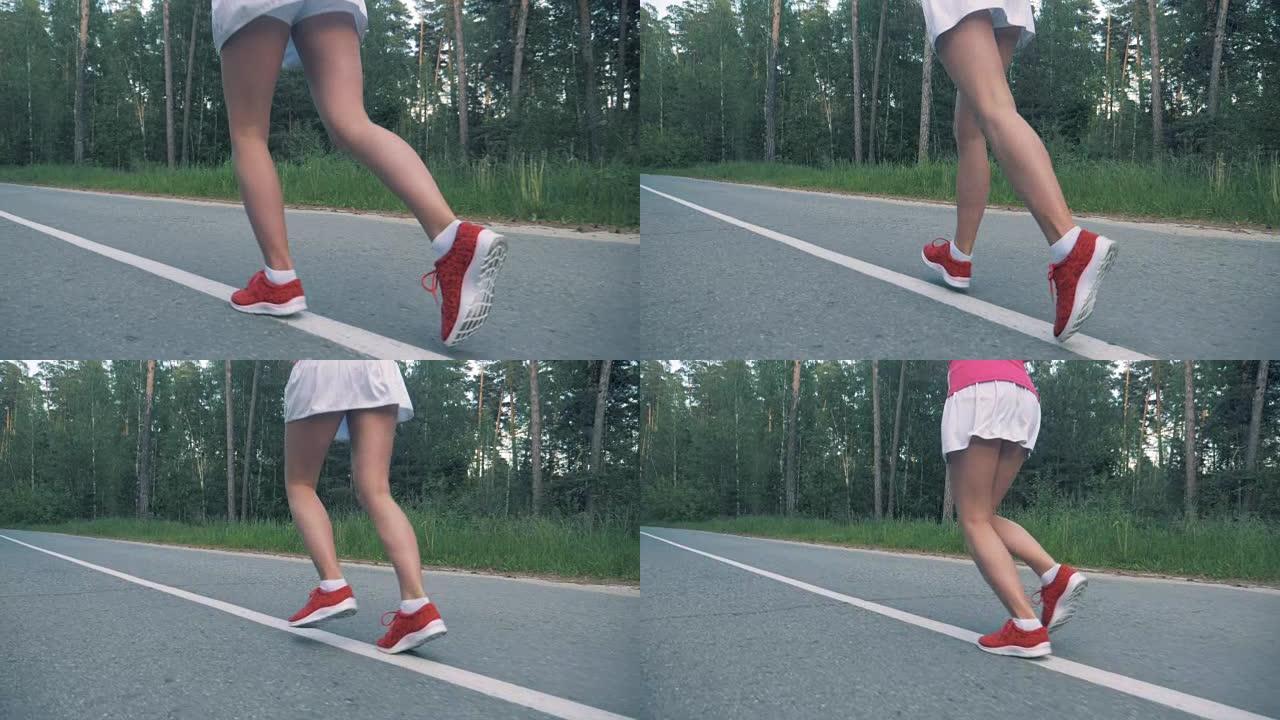 健康的生活方式理念。女性慢跑的慢动作镜头。