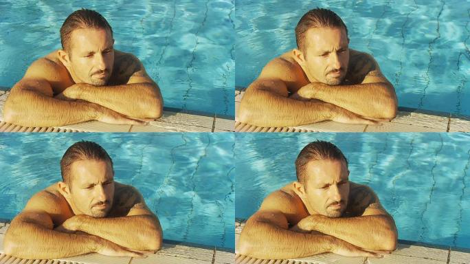 高清：男子在泳池边放松