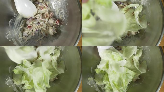 健康年轻厨师扔美味的有机绿色沙拉的俯视图。