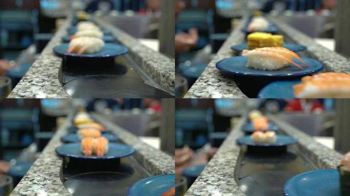 寿司和生鱼片。在传送带上滚动的寿司和生鱼片菜肴。日本传统生活方式。