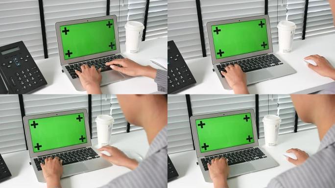 女商人在办公室的电脑笔记本电脑上使用，绿屏