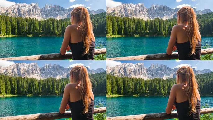 多洛米蒂山脉湖上的女性游客看着令人叹为观止的景色