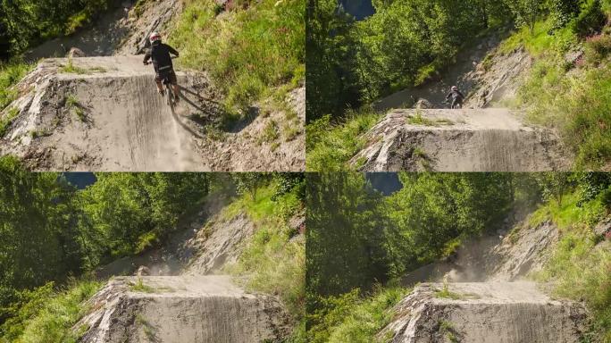 下坡山地自行车手在泥泞的赛道上骑行，在运动坡道上表演跳跃特技自行车鞭