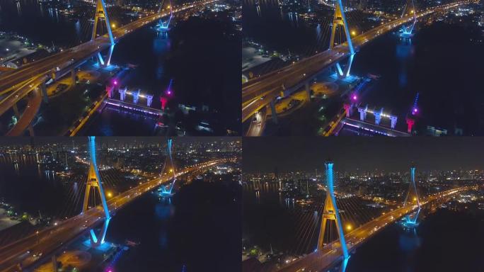 普密蓬大桥工业环桥两次穿越湄南河的鸟瞰图。泰国曼谷新地标的暮色，灯光秀和日落场景