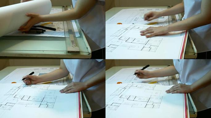 女建筑师在办公桌上研究计划，带计划，4K(UHD)