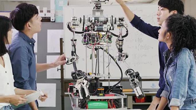 青少年在机器人俱乐部项目中研究功能齐全的可编程机器人。创意设计师在车间测试机器人原型。科学概念