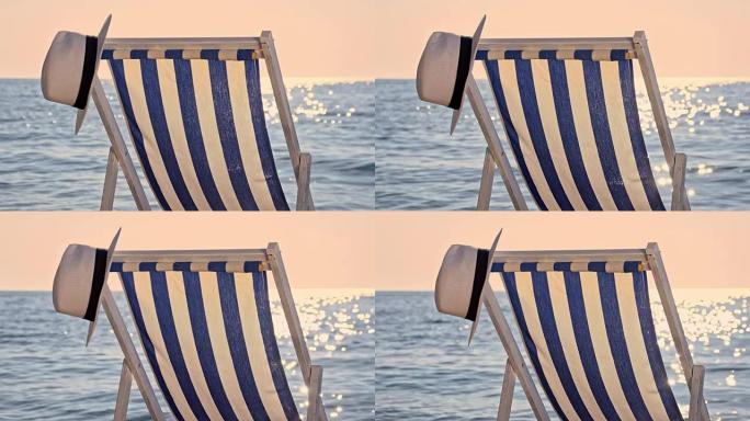 沙滩上的SLO MO男夏季帽子和椅子