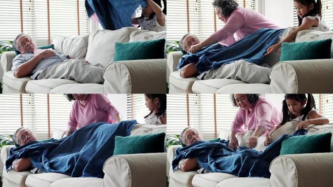 泰国家庭在家: 老年，休息，舒适和人们的观念-老妇人和女孩用毯子照顾老人