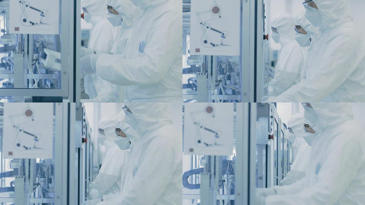 在一个工厂团队的科学家们在无菌防护服工作在一个现代工业3D打印机械。制药、生物技术和半导体创造/制造