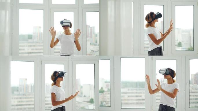 穿着便服的非裔美国女孩站在公寓里时正在使用虚拟现实眼镜和手势。现代科技、娱乐和人的概念。
