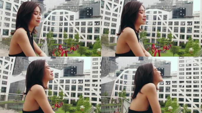 夏天城市里穿吊带的中国女孩看镜头迷人微笑